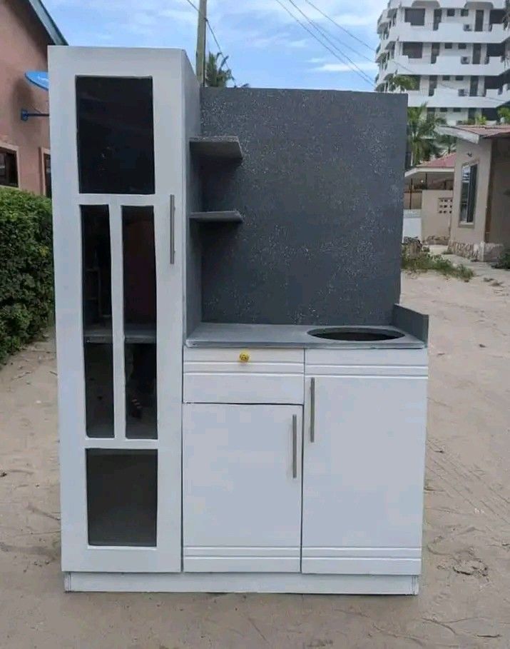 Kitchen cabinet with gas stove and one tall door for utensils